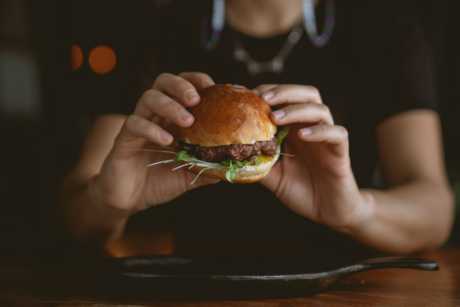 Person Holding Burger With Lettuce